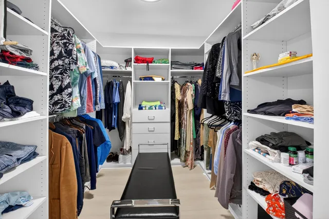 a view of swimming pool with a table and chairs and potted plants