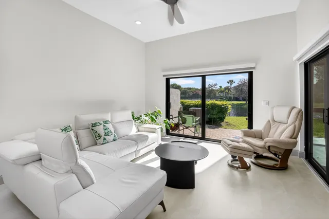a living room with furniture and a potted plant