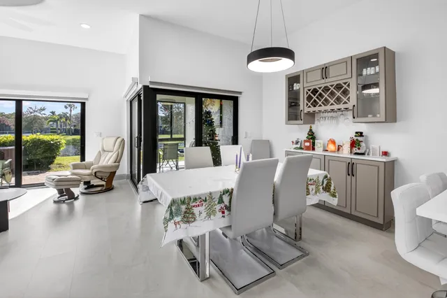 a dining room with furniture and a chandelier