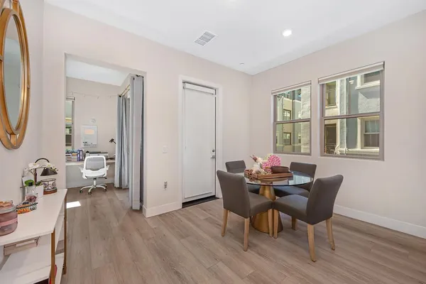 a view of a dining room with furniture and wooden floor