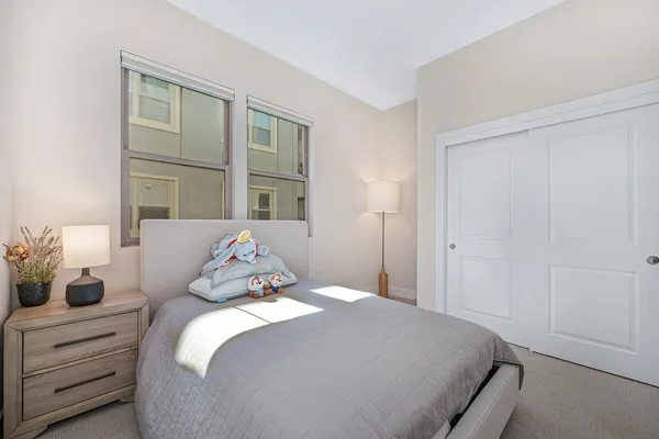 a bedroom with a bed and a couch