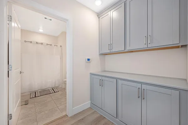 a bathroom with a sink toilet vanity and shower