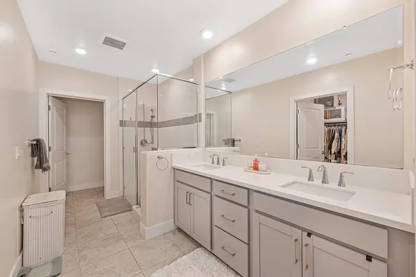 a bathroom with a sink a toilet and a shower