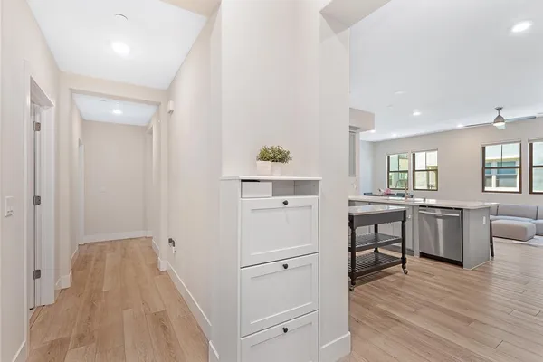 a kitchen with stainless steel appliances granite countertop a refrigerator a stove and white cabinets