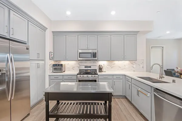a kitchen that has a sink and a stove in it