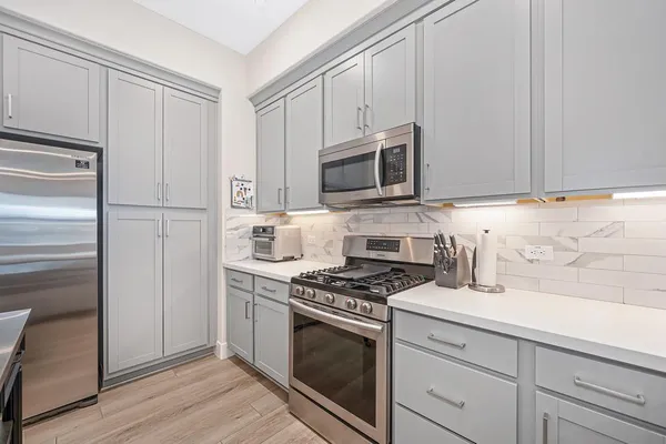 a room with a sink and a stove top oven