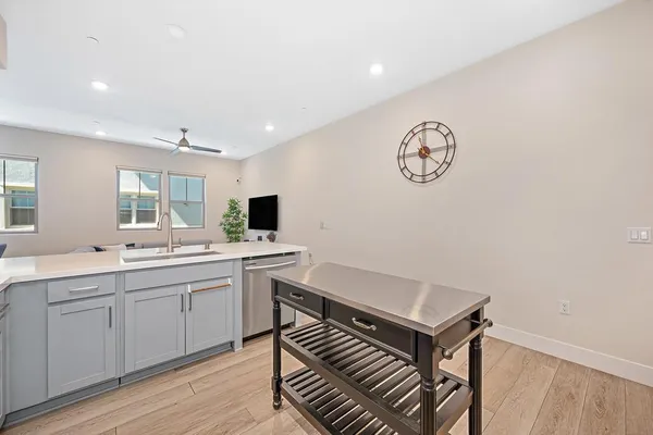 a kitchen with cabinets stainless steel appliances and a sink