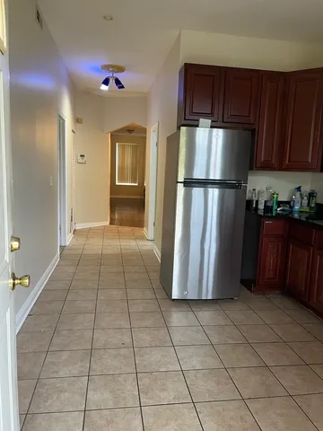 a kitchen with a refrigerator and cabinets