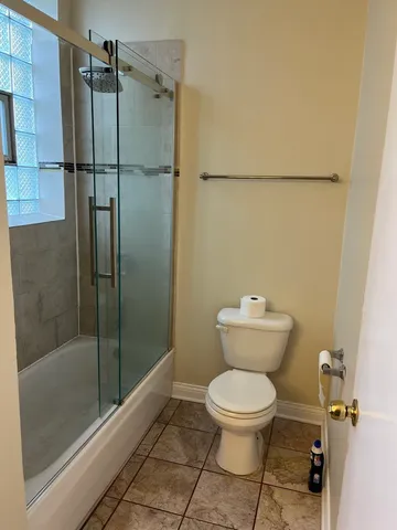 a bathroom with a toilet and a shower