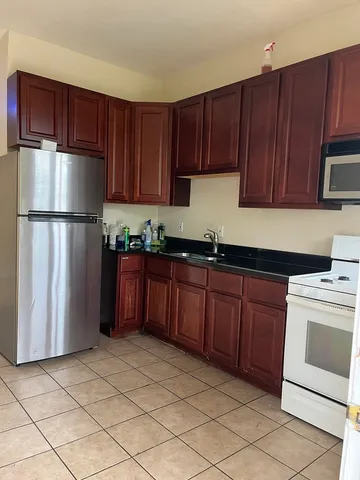 a kitchen with stainless steel appliances granite countertop a refrigerator sink and cabinets