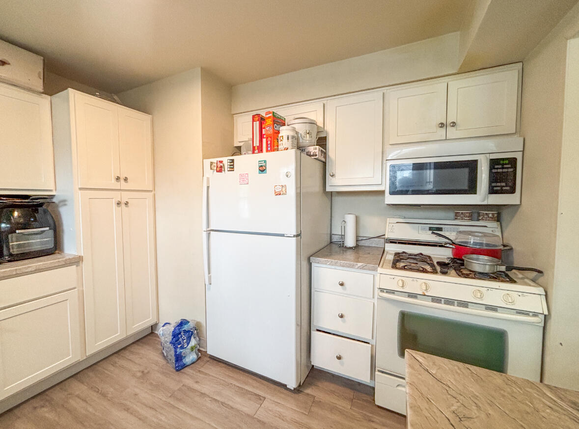 6844 Ridgeland Avenue Hammond, IN 46324 - Photo 7 of 21 a kitchen with a refrigerator stove and white cabinets