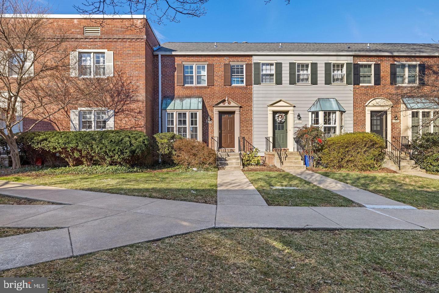 4940 Bradley Boulevard, Unit 247 Chevy Chase, MD 20815 - Photo 1 of 25 a front view of a house with garden