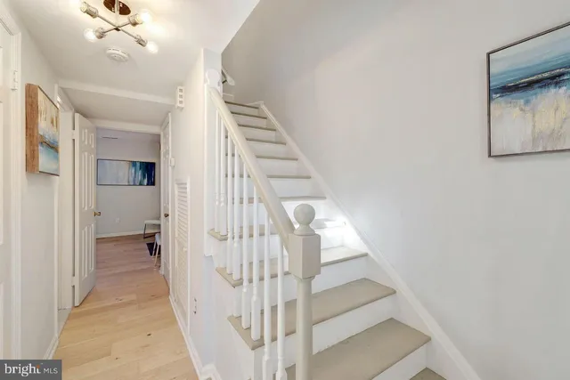 a view of entryway and hall with wooden floor