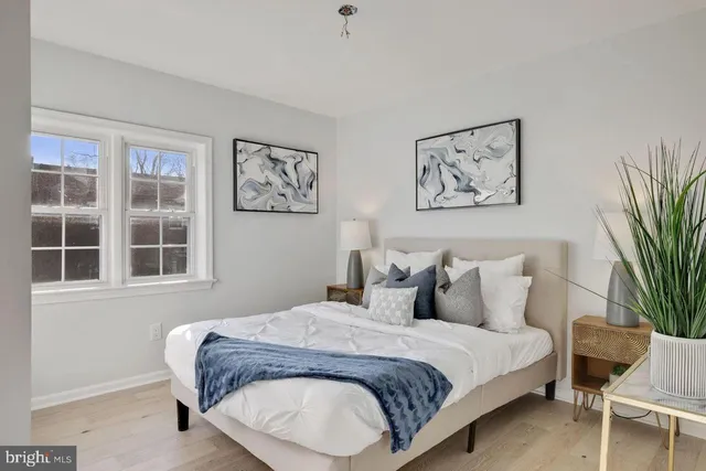 a bedroom with a large bed and a window