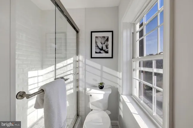 a bathroom with a toilet and a shower