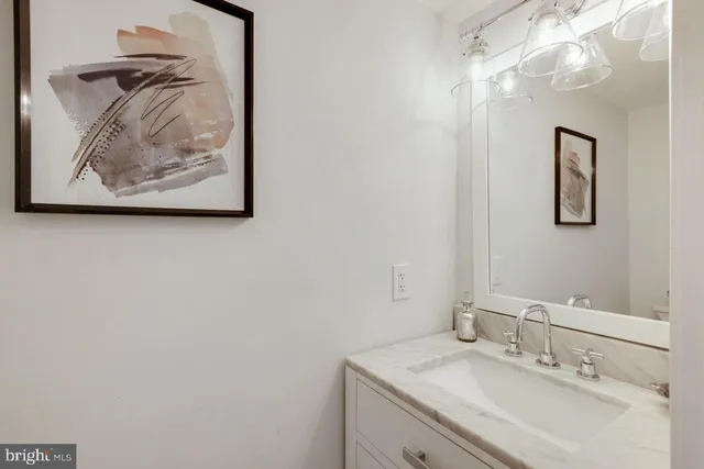 a bathroom with a sink vanity and a mirror
