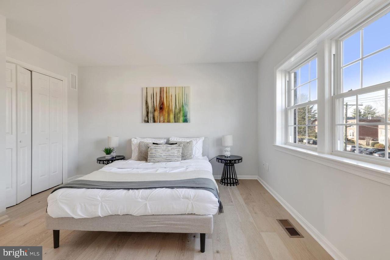 4940 Bradley Boulevard, Unit 247 Chevy Chase, MD 20815 - Photo 20 of 25 a bedroom with a bed a painting and a window
