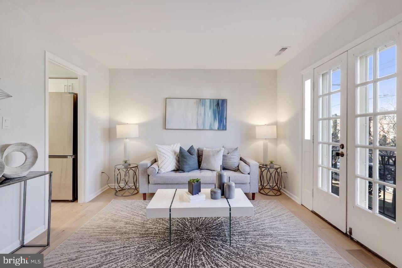 4940 Bradley Boulevard, Unit 247 Chevy Chase, MD 20815 - Photo 2 of 25 a living room with furniture and a rug