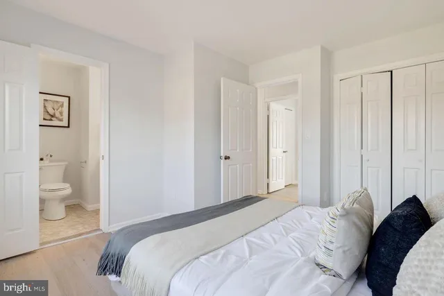 a bedroom with a bed and a view of bathroom