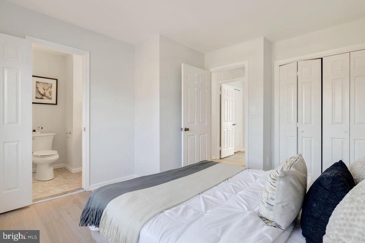 4940 Bradley Boulevard, Unit 247 Chevy Chase, MD 20815 - Photo 22 of 25 a bedroom with a bed and a view of bathroom
