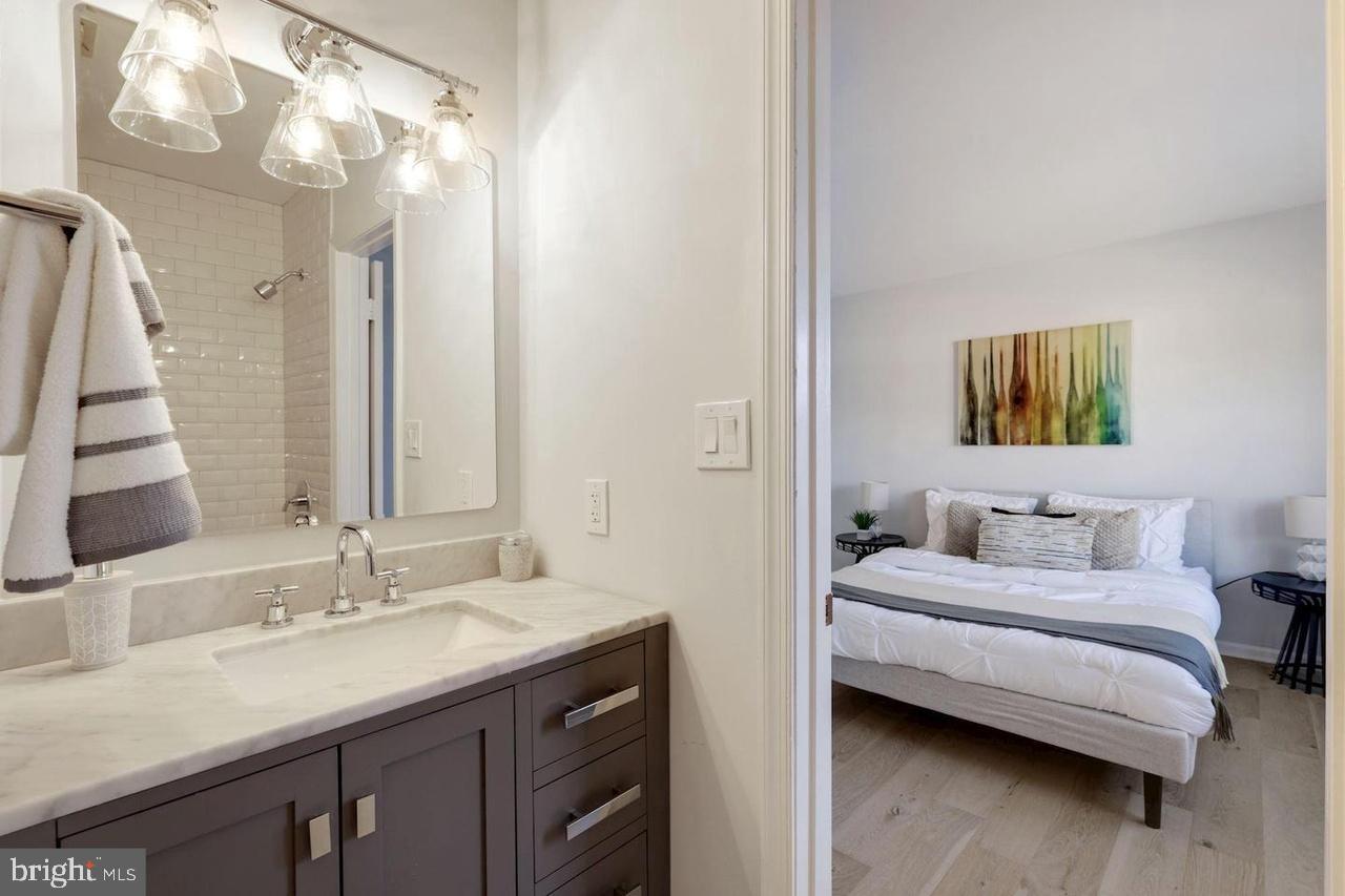 4940 Bradley Boulevard, Unit 247 Chevy Chase, MD 20815 - Photo 24 of 25 a en suite bathroom with a double vanity sink and a mirror