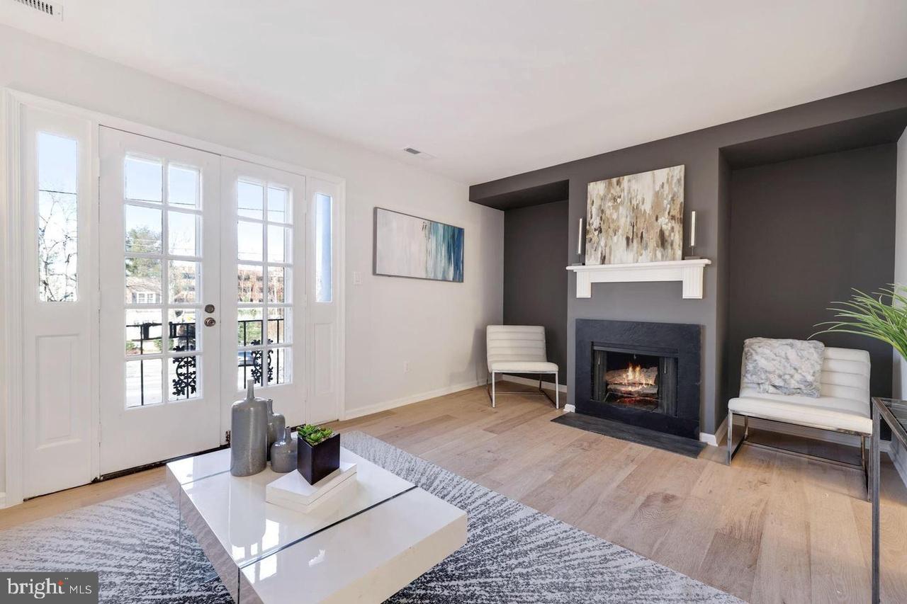 4940 Bradley Boulevard, Unit 247 Chevy Chase, MD 20815 - Photo 6 of 25 a living room with furniture and a fireplace