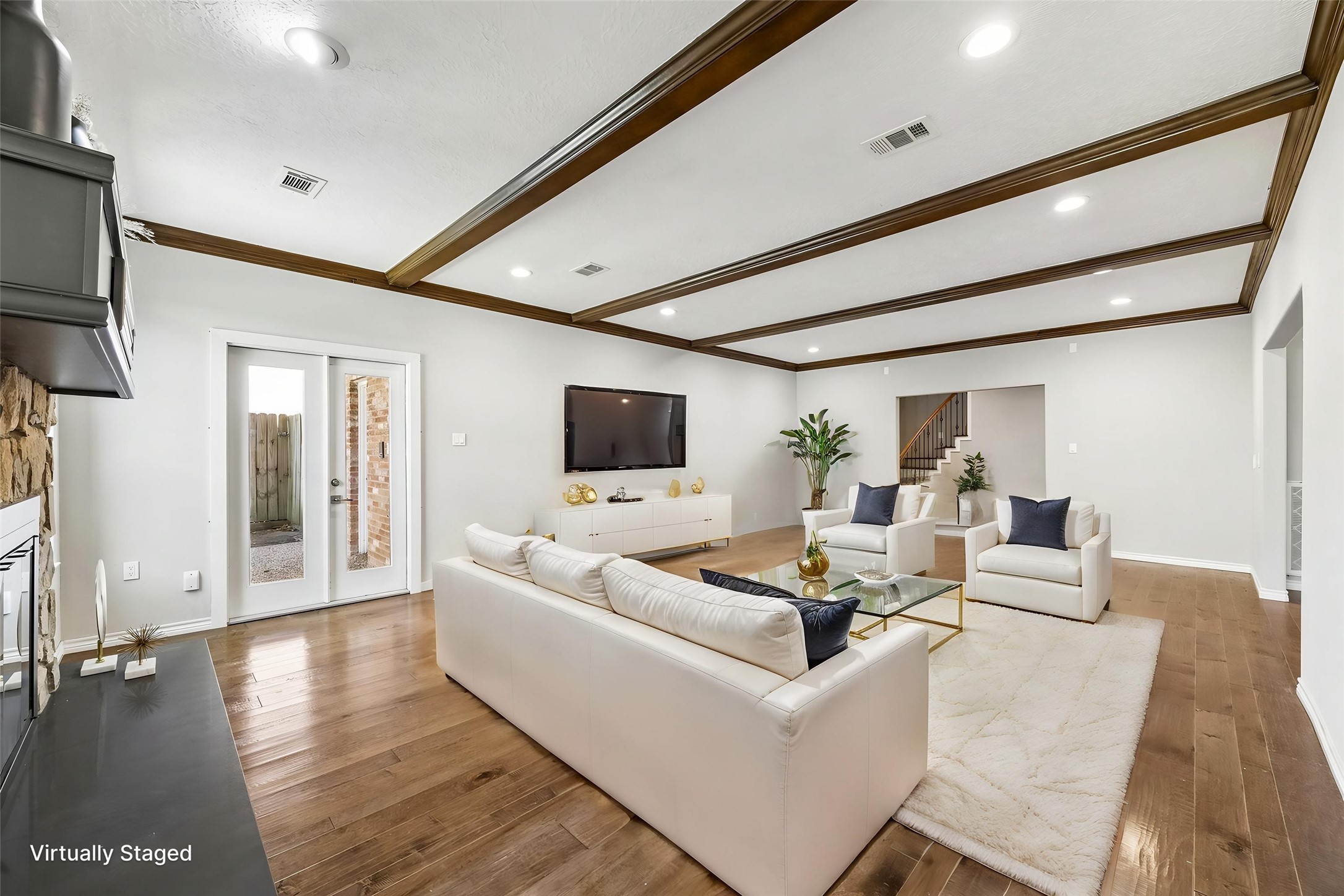 1030 Crossroads Drive Houston, TX 77079 - Photo 11 of 44 a living room with furniture wooden floor and a flat screen tv