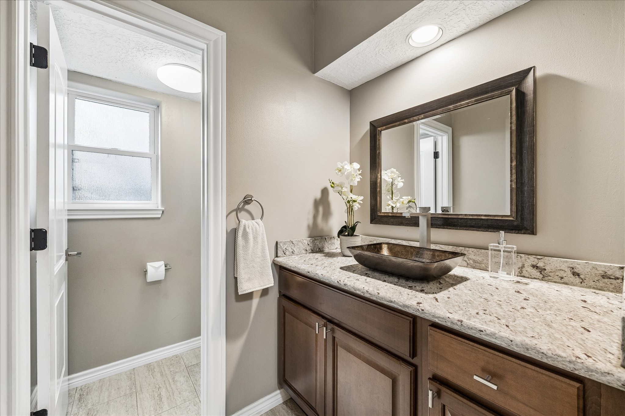 1030 Crossroads Drive Houston, TX 77079 - Photo 19 of 44 a bathroom with a granite countertop sink and a mirror
