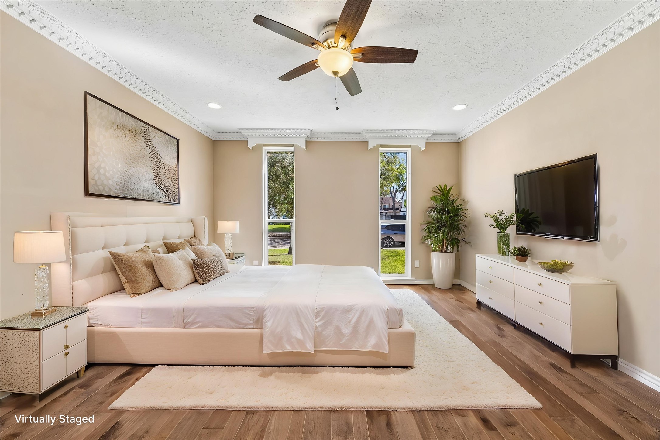 1030 Crossroads Drive Houston, TX 77079 - Photo 20 of 44 a bedroom with a bed and a flat screen tv on dresser