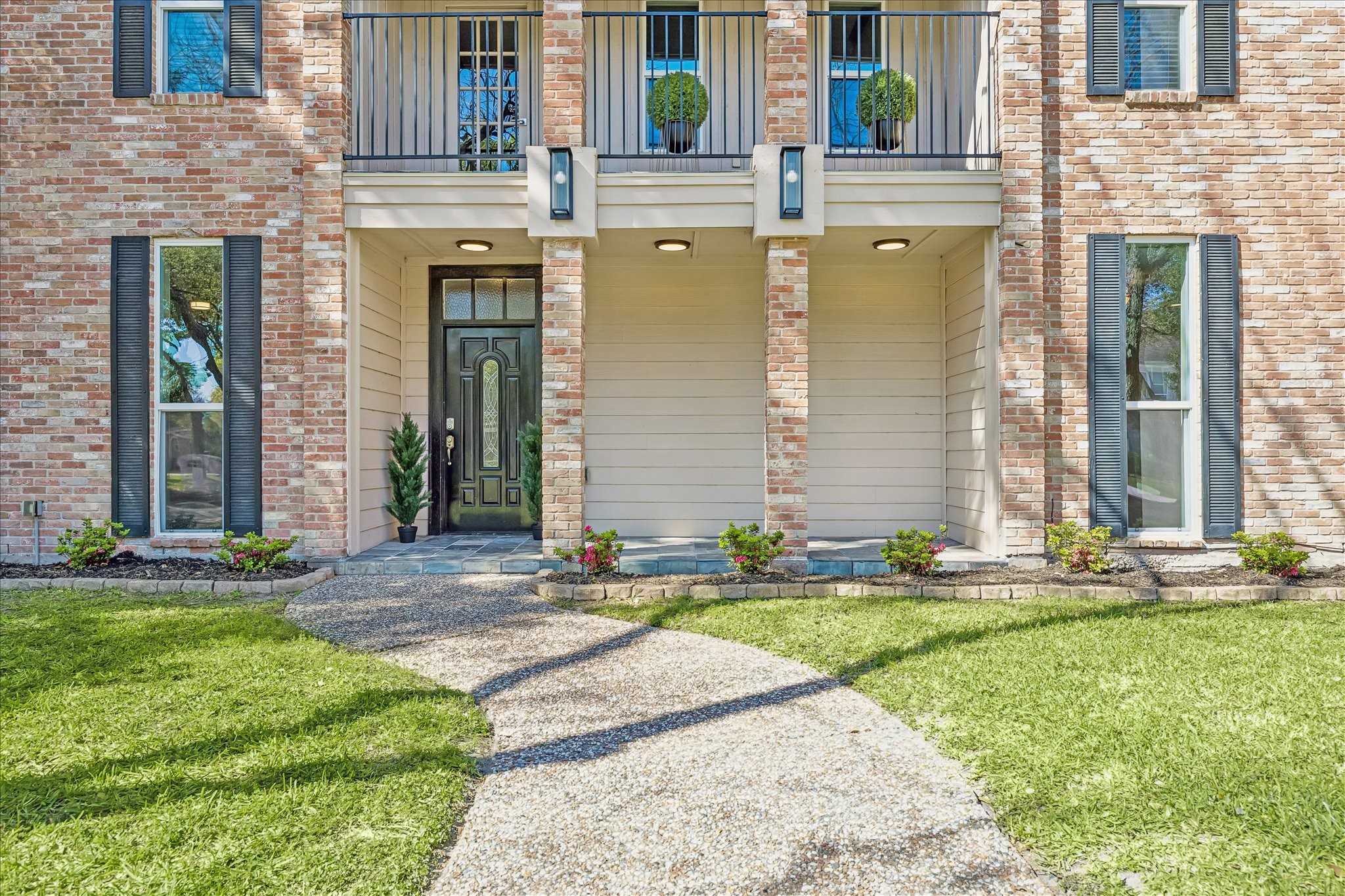 1030 Crossroads Drive Houston, TX 77079 - Photo 2 of 44 a front view of a house with a yard