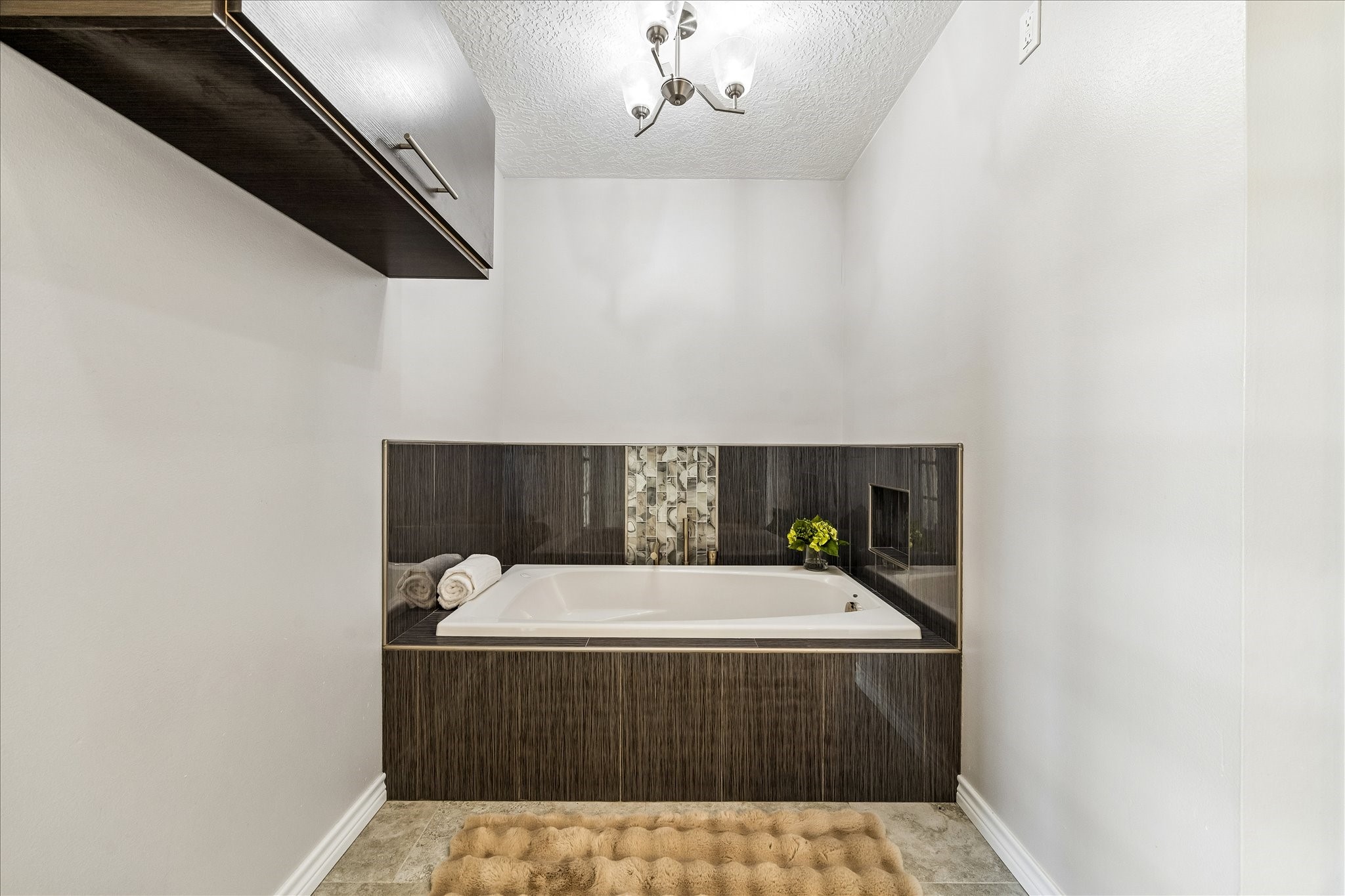 1030 Crossroads Drive Houston, TX 77079 - Photo 23 of 44 a room with a bed and a chandelier