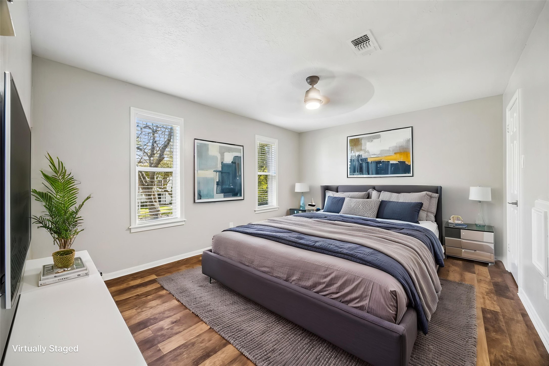 1030 Crossroads Drive Houston, TX 77079 - Photo 29 of 44 a spacious bedroom with a large bed a potted plant and windows