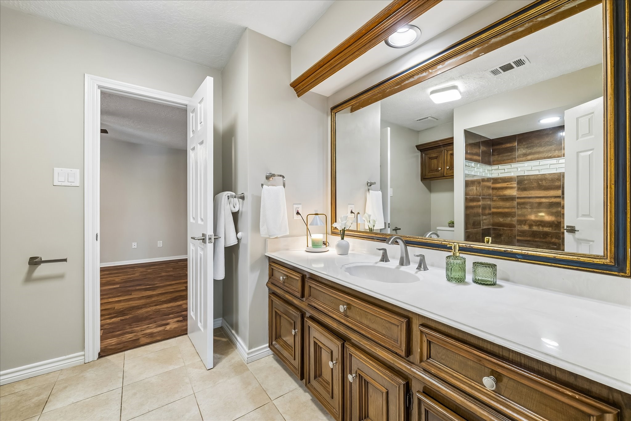 1030 Crossroads Drive Houston, TX 77079 - Photo 34 of 44 a bathroom with a sink a mirror and a shower