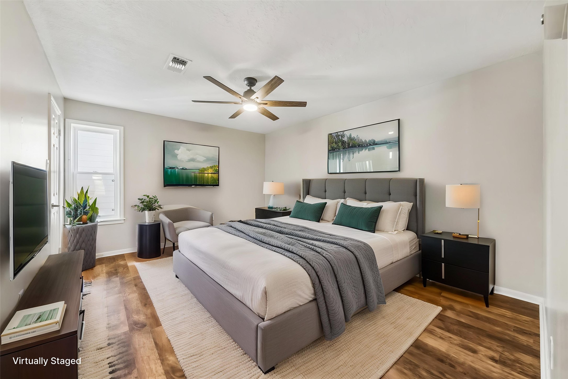 1030 Crossroads Drive Houston, TX 77079 - Photo 35 of 44 a bedroom with a large bed a chandelier and a flat screen tv