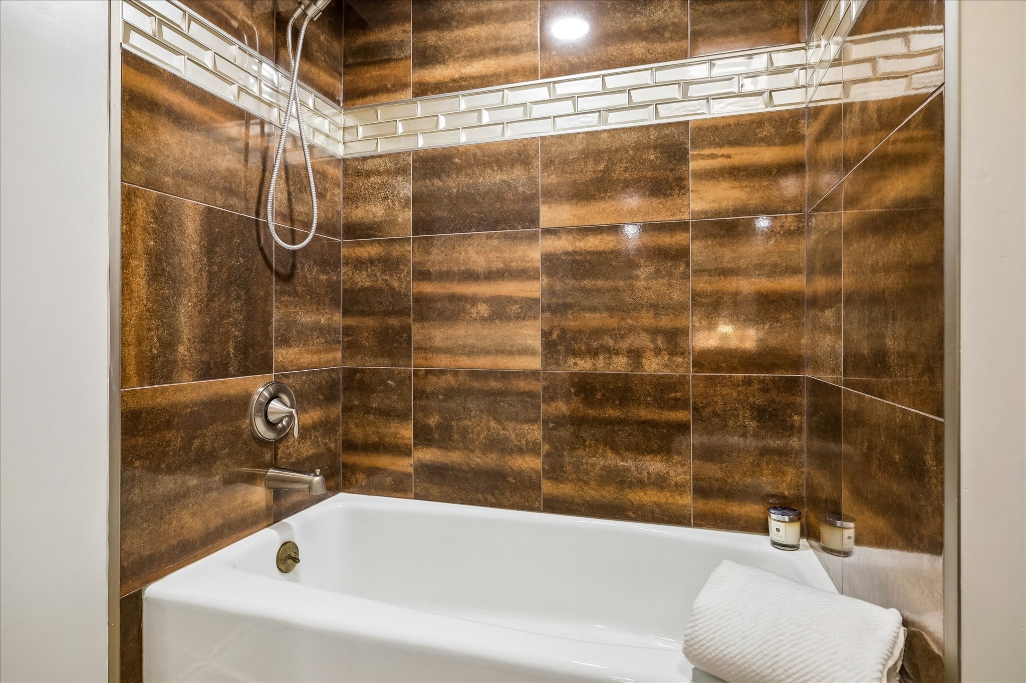 1030 Crossroads Drive Houston, TX 77079 - Photo 36 of 44 a bathroom with a shower and a white bath tub sitting next to a bathroom