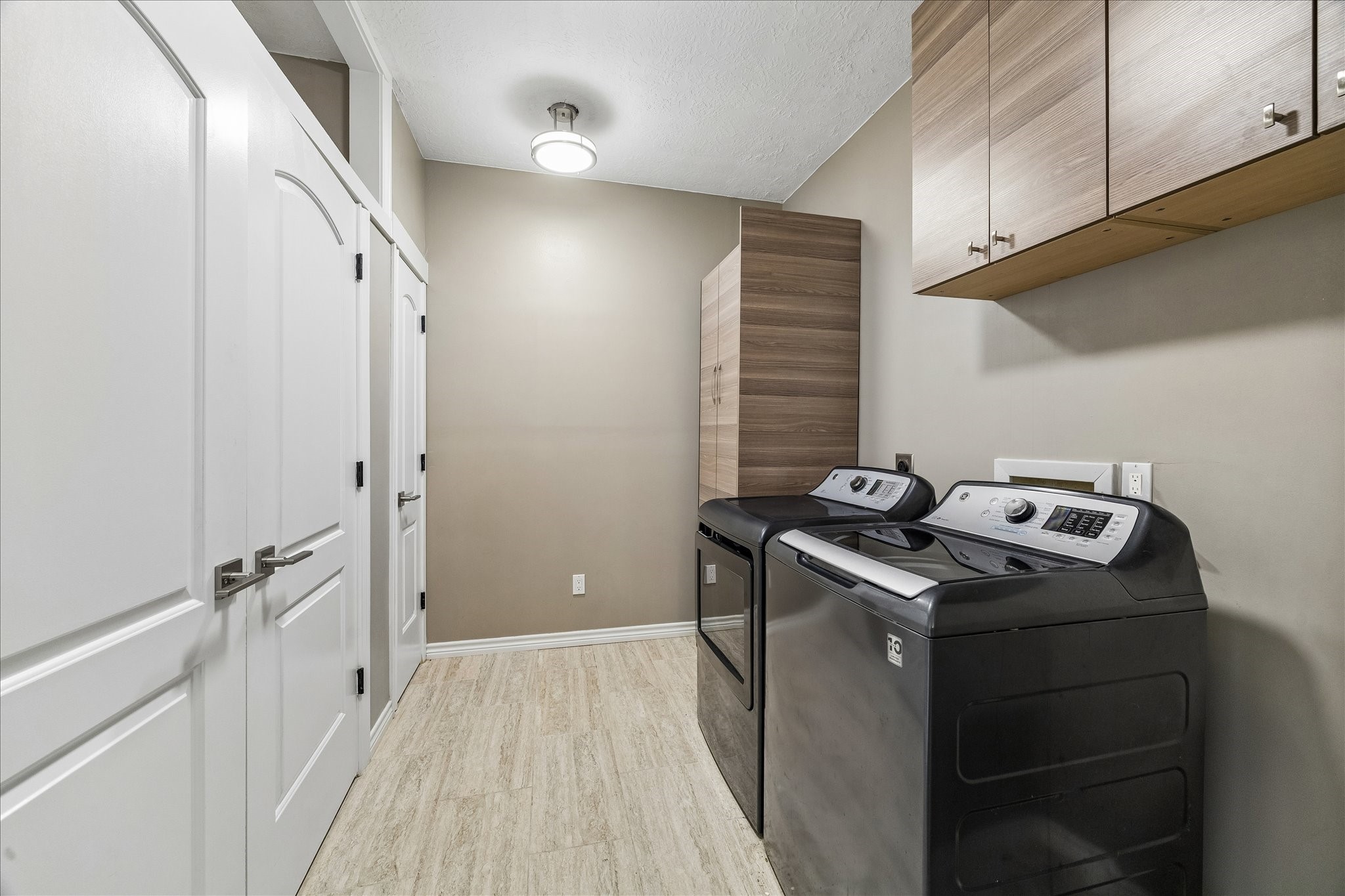 1030 Crossroads Drive Houston, TX 77079 - Photo 43 of 44 Extra-large utility room with BUILT-IN STORAGE offering excellent functionality, organization, and everyday convenience.