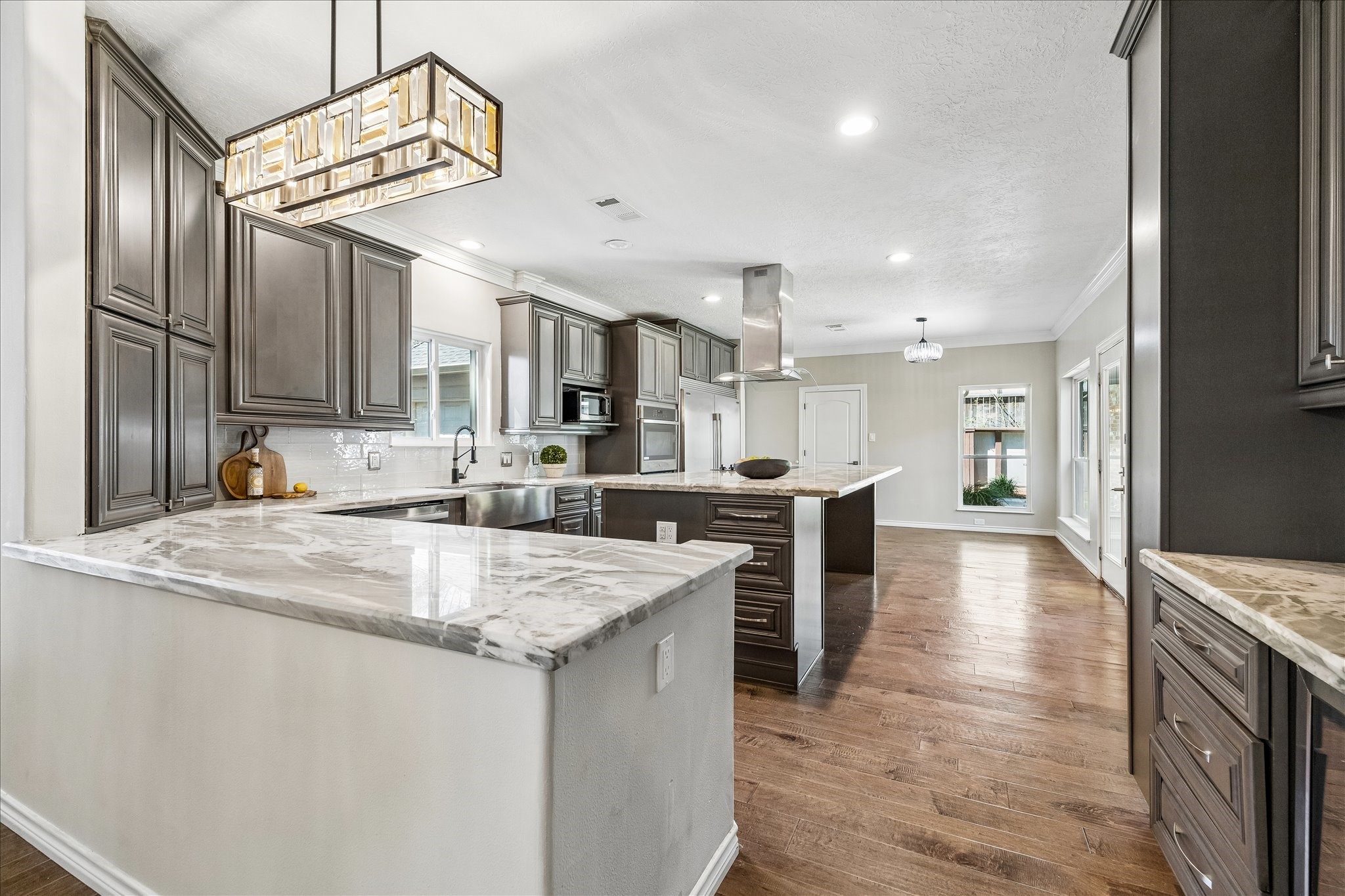 1030 Crossroads Drive Houston, TX 77079 - Photo 8 of 44 a large kitchen with stainless steel appliances lots of counter space and wooden floor
