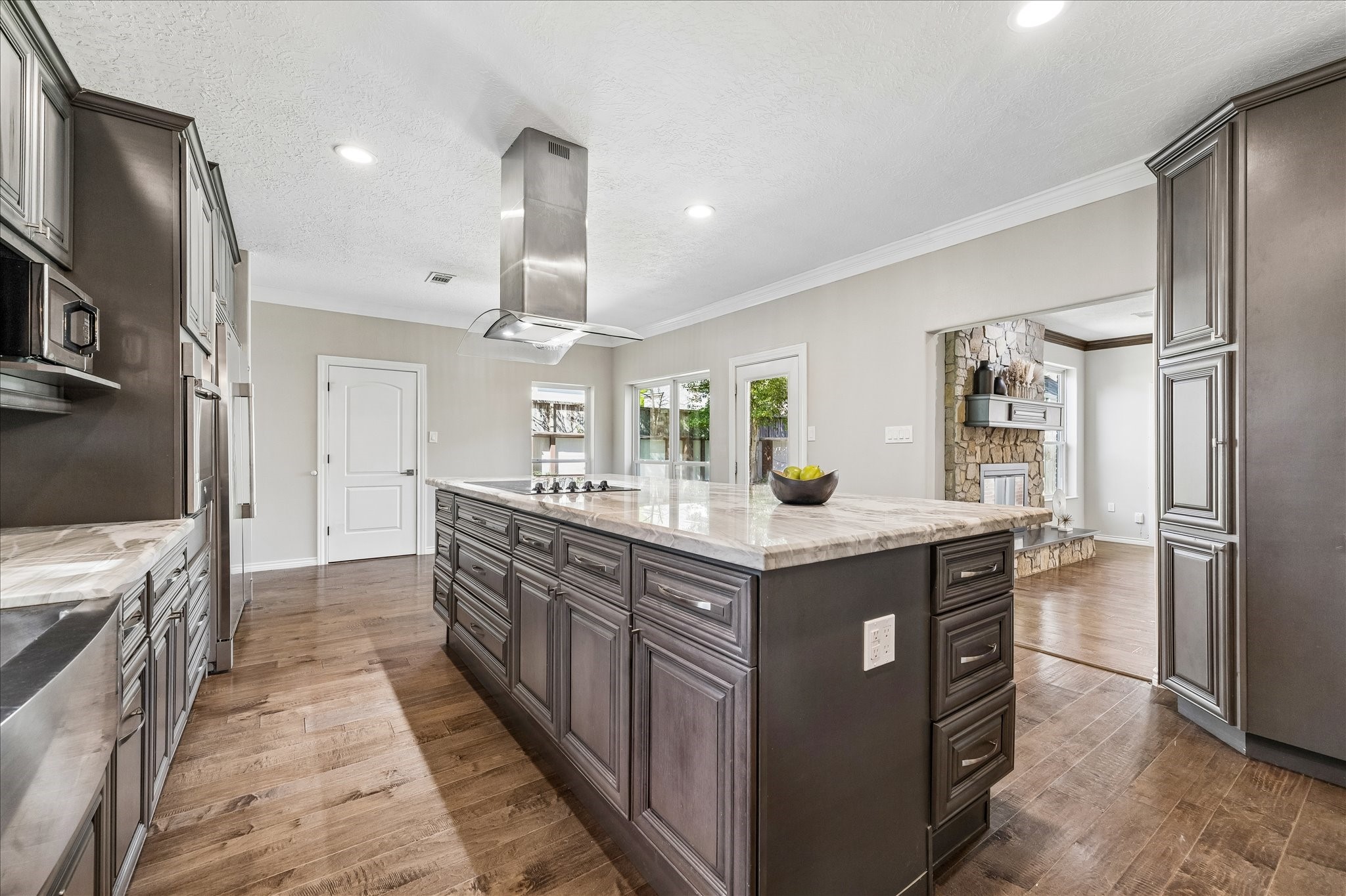 1030 Crossroads Drive Houston, TX 77079 - Photo 10 of 44 a kitchen with stainless steel appliances granite countertop a kitchen island a stove a refrigerator and a sink