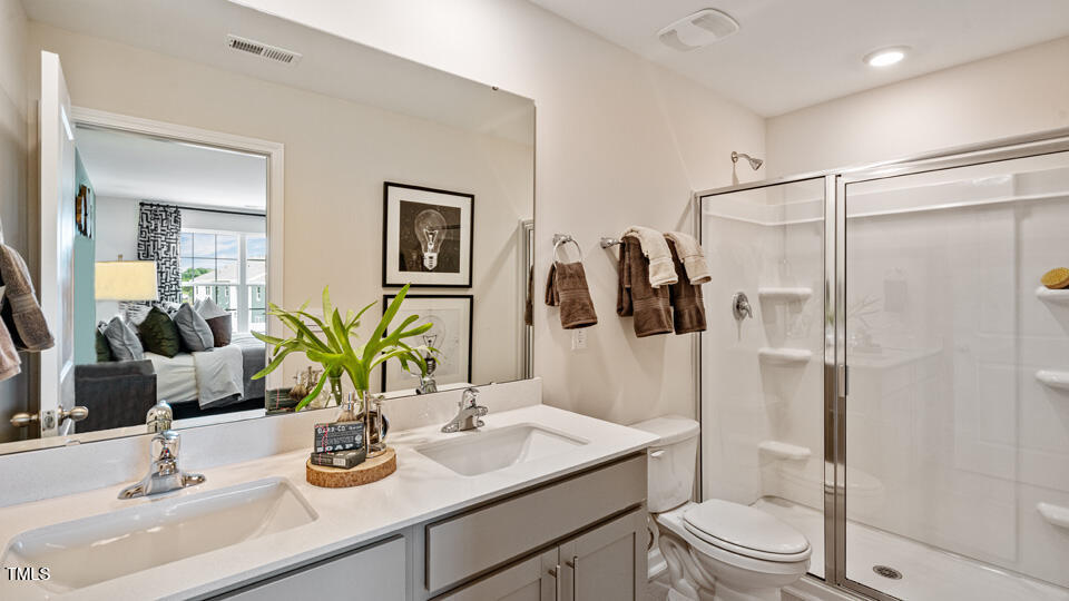 405 Belgian Red Way Rolesville, NC 27571 - Photo 18 of 28 a bathroom with a granite countertop sink toilet and shower