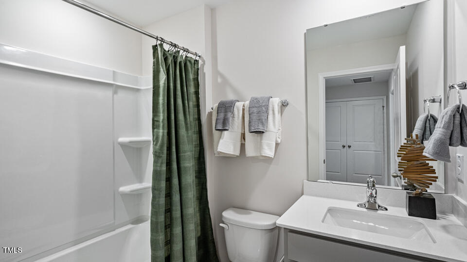 405 Belgian Red Way Rolesville, NC 27571 - Photo 22 of 28 a bathroom with a sink a toilet and shower