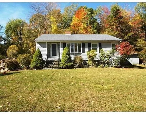23 Adams Road Grafton, MA 01519 - Photo 1 of 32 a front view of house with yard and trees around