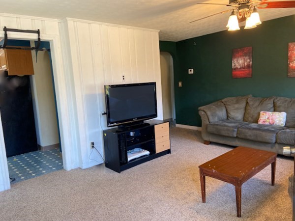 23 Adams Road Grafton, MA 01519 - Photo 13 of 32 a living room with furniture and a flat screen tv