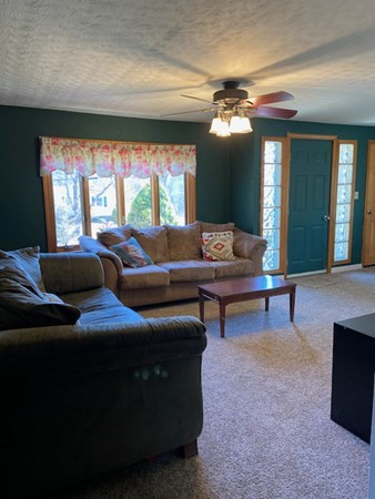 23 Adams Road Grafton, MA 01519 - Photo 16 of 32 a living room with furniture and a large window