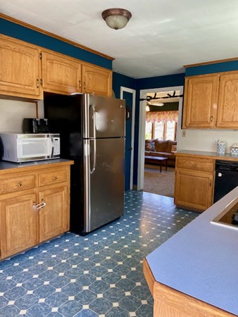 23 Adams Road Grafton, MA 01519 - Photo 19 of 32 a kitchen with refrigerator and cabinets