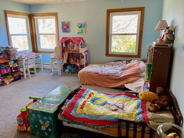 23 Adams Road Grafton, MA 01519 - Photo 24 of 32 a bedroom with two beds and a window