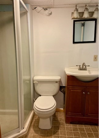 23 Adams Road Grafton, MA 01519 - Photo 29 of 32 a bathroom with a sink a toilet and shower