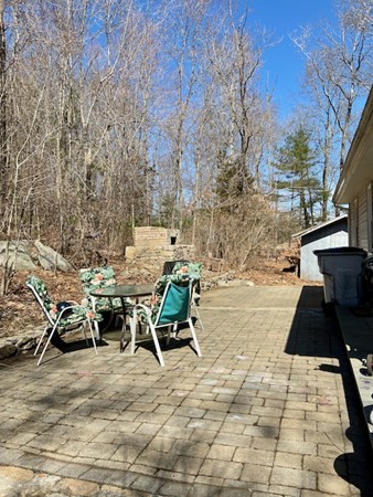 23 Adams Road Grafton, MA 01519 - Photo 7 of 32 a view of backyard with seating space and trees