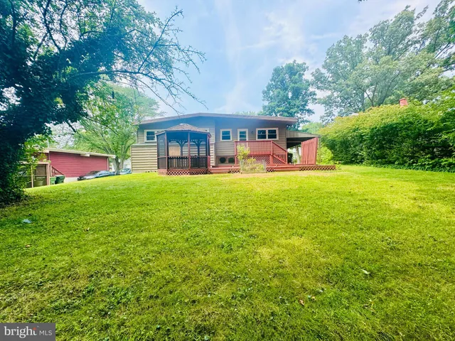 a view of a house with a yard porch and sitting area
