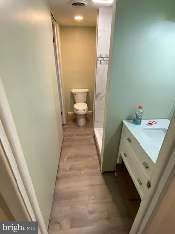 a bathroom with a sink a toilet and a mirror