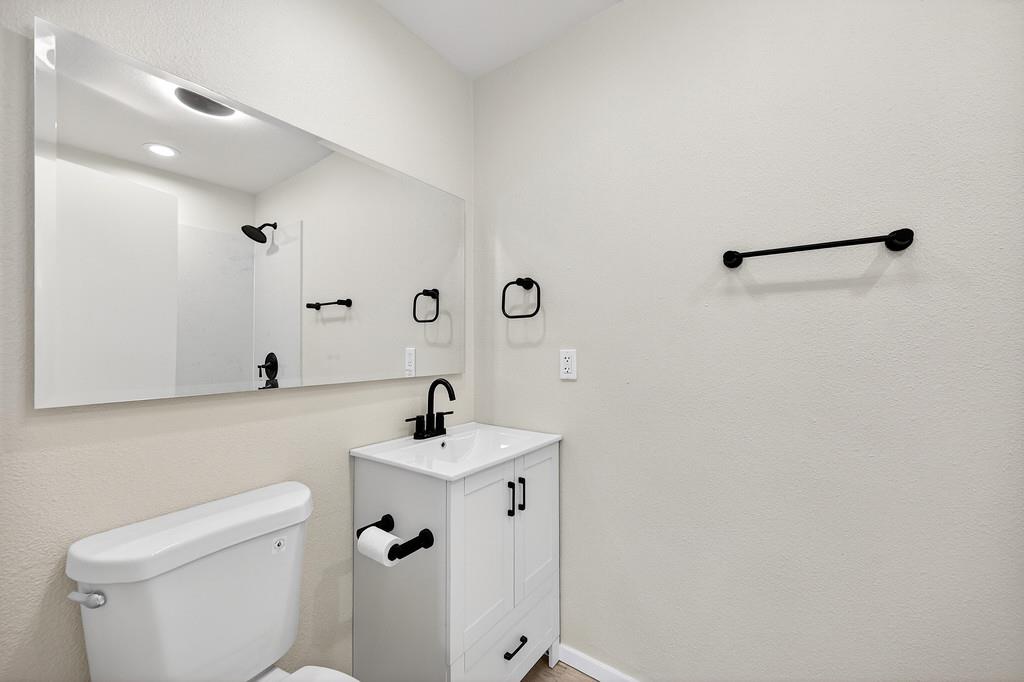 3901 Luneman Road Placerville, CA 95667 - Photo 15 of 56 a bathroom with a sink a toilet and mirror